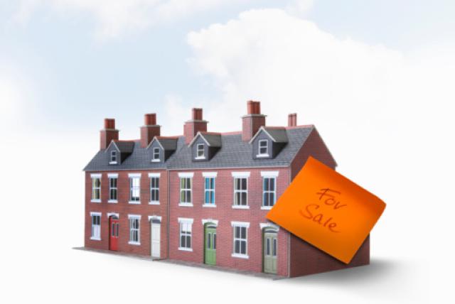 Row of model houses with for sale sticker